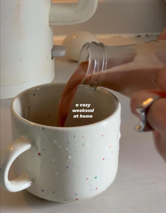 Coffee being poured into a speckled ceramic cup during a daily ritual